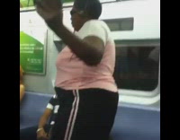 Woman with headphones and cd player dances to music on the subway