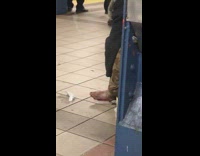 Person scratching ashy foot subway station
