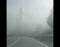 Car ride through a foggy mountain road