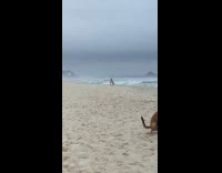 Man lift woman for photo at beach