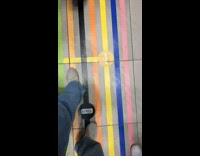 Little boy laying in middle of colorful line walkway 