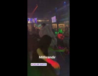 Guy dressed as Gandalf wizard lord of the rings dances in the club