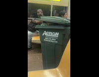 Man bring trash bin inside subway train