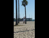 girl white shirt lean tree beach windy