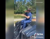 Blue scrubs doctor black convertible sports car 