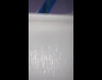 Lady changes writing on blue tape