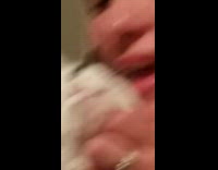 Lady Pets Clingy Cat as she Holds it