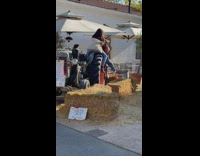 Two girls sit on large wheel truck