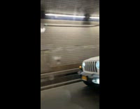 Man in white jeep plays trumpet while driving