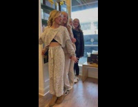 Four women with their hair done poses inside the salon