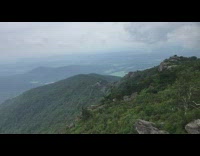 View from mountain green trees white clouds 