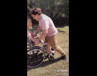 Guy push girl pink wheelchair face down