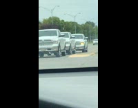 Three trucks the exact same color with blinker on