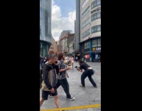 Man red pants makes square dance video