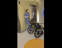 Nurse and girl in wheelchair sing together 