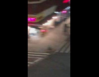 person in white hat airhorn street