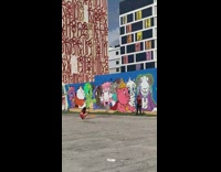 Man whip lasso beside animal characters mural