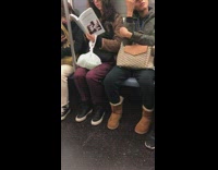 Woman reads book titled Aliens and Anorexia on subway train