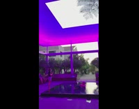 Guy white hat sit fountain black light