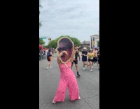 Woman wears face cardboard dance at marathon