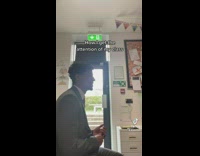 Teacher guy in suit sings and class responds and stops talking