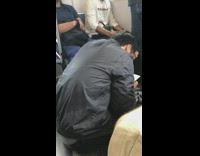 Guy sits on floor of subway and sings