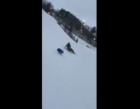 Skier pushes guy in between legs downhill and jumps off ramp