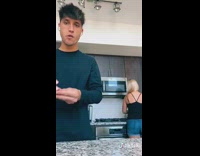 Guy shoots grapes at sister in kitchen