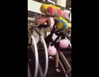 Guy carries backpacks sleeping campings bags and kettlebells on his back and uses stairmaster machine stairs