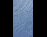 Man snowboards down hill lands head first