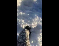 Woman steps knee deep in tall snow