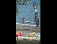 Woman thong kneel on paddle board beach