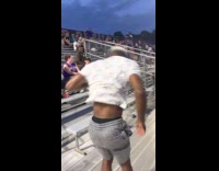 Man with white shirt tumbles on bleachers