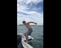 Guy chugs beer backflip boat lake water