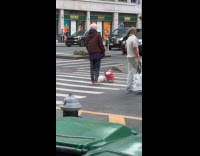 Man stands still in middle of crosswalk 