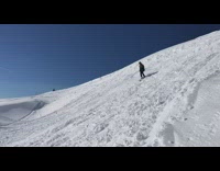 Skier does back flip in the snow, skis get stuck in the snow