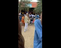 Girl poses for photo outside 