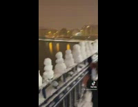 Line of snowmen balls stacked on rail
