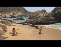 Blonde Girl in Bikini Kneels on Sand for Photo