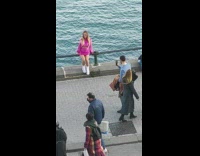 Woman pink clothes sit pose on railings