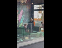 Waiter talk to woman pose on green sofa