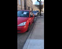 Red car with signs taped to it