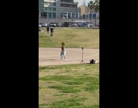 Woman in brown crop top tiktok dance at the park