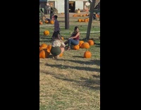 Woman tank top sit pumpkin  windy kids