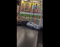 Man sleeping on the floor of subway