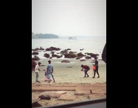 Five men skit video kneel punch beach