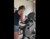 Woman operate old fashioned letterpress machine Invitation