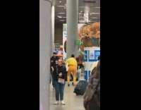 Four women tiktok dance inside the airport