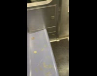 Red and green salsa sauce spilled all over blue seats on subway train
