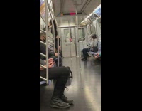 Black pants girl hangs upside down subway 